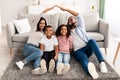 Black parents making symbolic roof of hands above their children