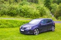 Black parked cars in the nature landscape of Norway