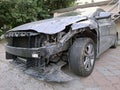 Black passenger car in wreck condition after road accident Royalty Free Stock Photo