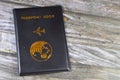 Black passport book with a plane and the globe earth on its cover, travel and tourism concept, universal passport book to protect Royalty Free Stock Photo