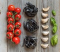 Black pasta with cherry tomatoes, garlic and basil Royalty Free Stock Photo