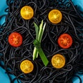 Black pasta with ink cuttlefish with yellow and red cherry tomatoes on blue plate, time to eat Royalty Free Stock Photo