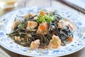 Black pasta with salmon and red caviar in cream sauce