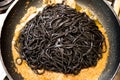 Black pasta squid ink pan up view italian taglierini al nero di seppia Royalty Free Stock Photo