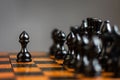 Black pawn, in front of the chess pieces. Strategy concept. Correct move. Business. Lifestyle Royalty Free Stock Photo