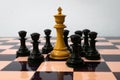 Black pawns surround the white chess king