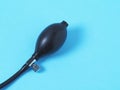 Black pear tonometer closeup on blue background. Close up, top view