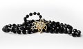 Black pearls necklace with golden brooch Royalty Free Stock Photo