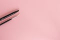 Black pen, pencil and brush on pink background Royalty Free Stock Photo