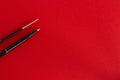 Black pen, pencil and brush on red background Royalty Free Stock Photo