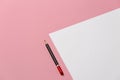 Black Pencil Lies On A Blank Sheet Of Paper On Pink Background, Top View. Office Space Creativity Minimalism Concept