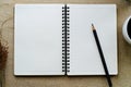 Black pencil on open white paper note book Royalty Free Stock Photo