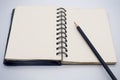 Black pencil on open white paper note book Royalty Free Stock Photo