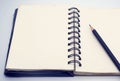 Black pencil on open white paper note book Royalty Free Stock Photo