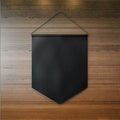 Black pennant hanging on the wall at wooden