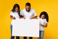 Black people holding blank white advertising billboard at yellow studio Royalty Free Stock Photo