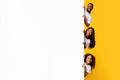 Black people peeking out blank white advertising billboard at studio Royalty Free Stock Photo