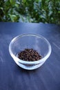 Black pepper in bowl on black background Royalty Free Stock Photo