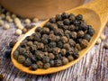 The black pepper corn on wood table for food concept Royalty Free Stock Photo