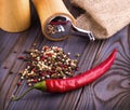 Black pepper corns, red hot chili pepper and Black pepper Powder on wooden background. Royalty Free Stock Photo