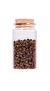 Black pepper in a glass bottle with cork stopper, isolated on wh Royalty Free Stock Photo