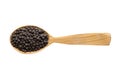 Black pepper grains in wooden spoon isolated on white background. spice for cooking food, top view Royalty Free Stock Photo