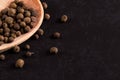 Black pepper peas in a wooden spoon scattered. Concept, copy space Royalty Free Stock Photo