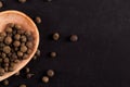 Black pepper peas in a wooden spoon scattered. Concept, copy space Royalty Free Stock Photo