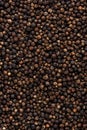 Black pepper, peppercorns, dry spice, food background texture, top view