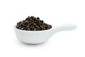 Black pepper pile or Black peppercorns seeds in ceramic bowl isolated on white background ,include clipping path Royalty Free Stock Photo