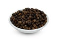 Black pepper pile or Black peppercorns seeds in ceramic bowl isolated on white background ,include clipping path Royalty Free Stock Photo