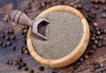 Black pepper powder in a bowl and scoop on table Royalty Free Stock Photo