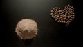 Black pepper powder and full pepper on the black table, top view Royalty Free Stock Photo