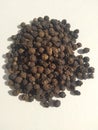 Black pepper seeds pile from top on white background Royalty Free Stock Photo