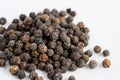 Black pepper seeds on a white background Royalty Free Stock Photo