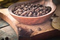 Black pepper in a spoon lies on a cutting board near the bay leaf on a background of blue boards