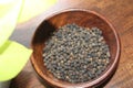 Black pepper in wooden bowl