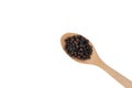 Black pepper in wooden spoon, black pepper seeds or peppercorns Royalty Free Stock Photo