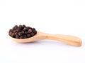 Black pepper in wooden spoon isolated on white background Royalty Free Stock Photo