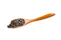 Black pepper on wooden spoon isolated on white background Royalty Free Stock Photo