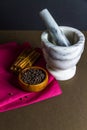 Black peppercorns, cinnamon sticks, pestle and mortar Royalty Free Stock Photo