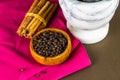 Black peppercorns, cinnamon sticks, pestle and mortar Royalty Free Stock Photo