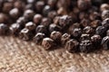 Black peppercorns on a hessian background Royalty Free Stock Photo