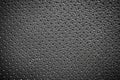 Black perforated leather texture background.