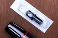 Black permanent tattoo pen with disposable cartridge on wooden table