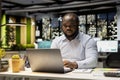 Black person examining archived documents before transcribing on notebook Royalty Free Stock Photo