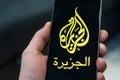 Black phone with logo of news media Al Jazeera on the screen Royalty Free Stock Photo