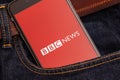 Black phone with red logo of news media BBC News on the screen