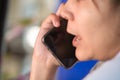 Close up of black phone screen While women with braces in their mouths In a blue t-shirt Are talking to liaise with business Have