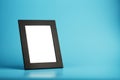 Black photo frame with empty space on a blue background Royalty Free Stock Photo